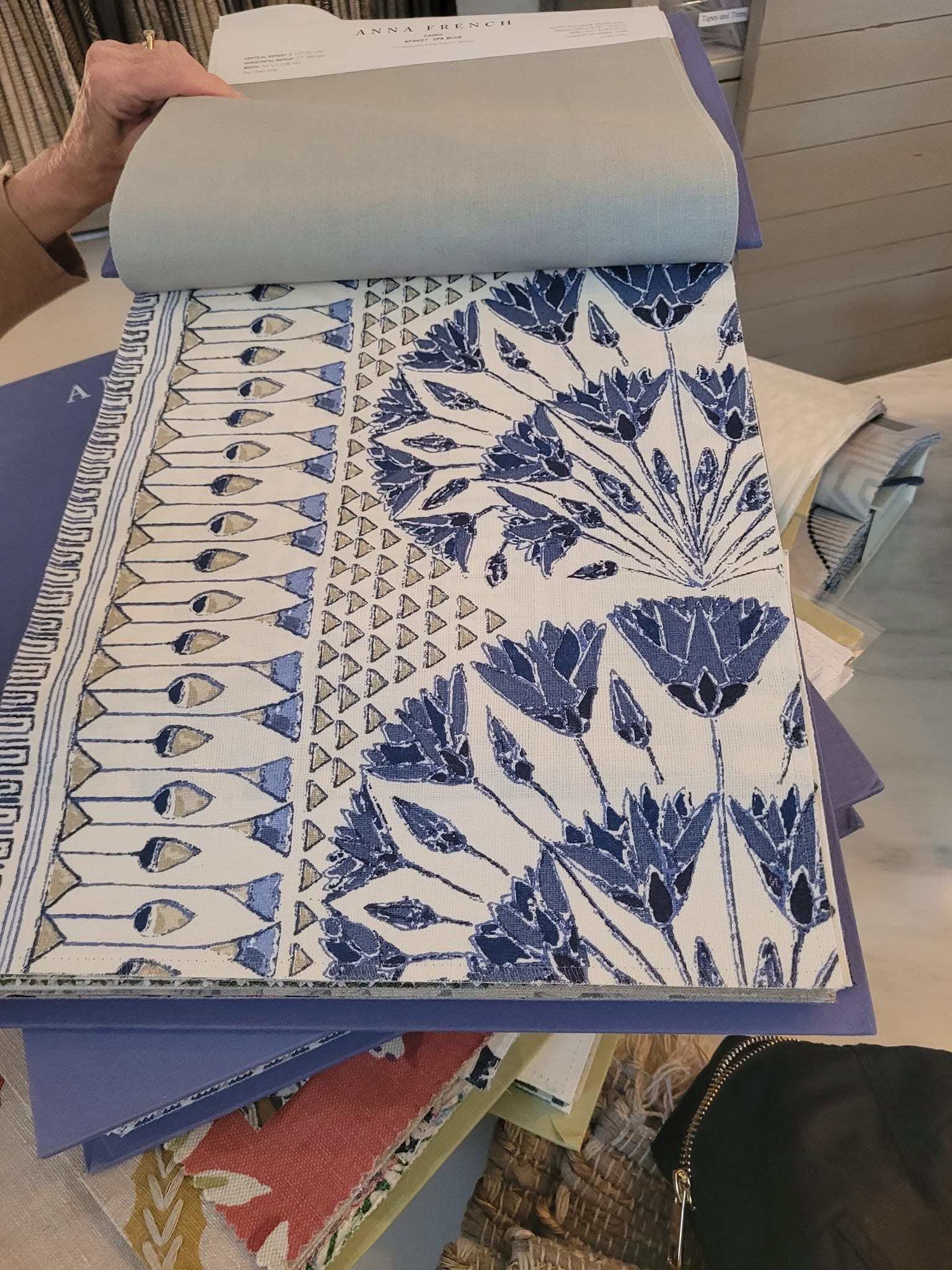 Patterned fabric samples held open in a stack