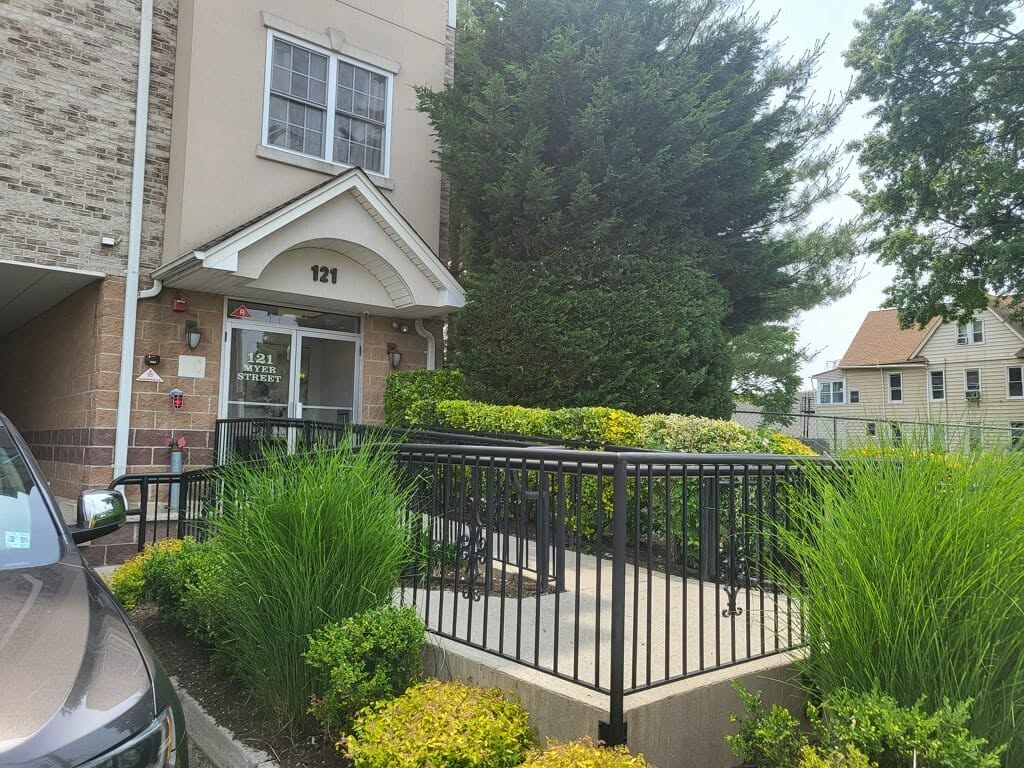 Building entrance with brick and painted exterior walls